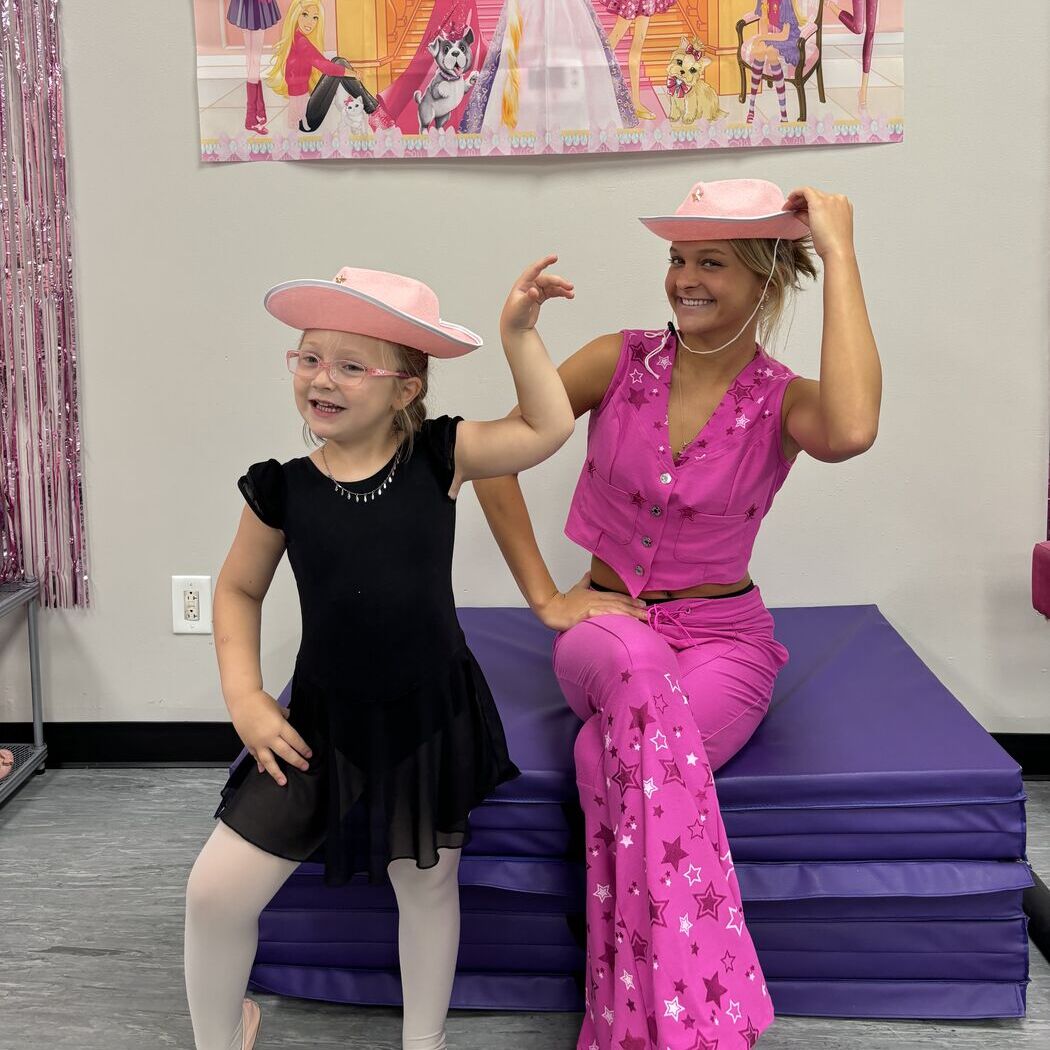 A Dance Makers teacher and young dancer posing in pink cowboy hats at a themed camp day